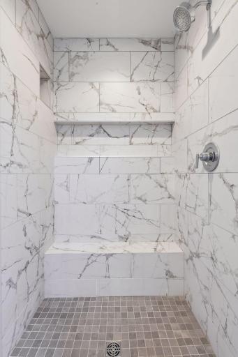 The large Primary Shower offers a built-in bench and glass enclosure.