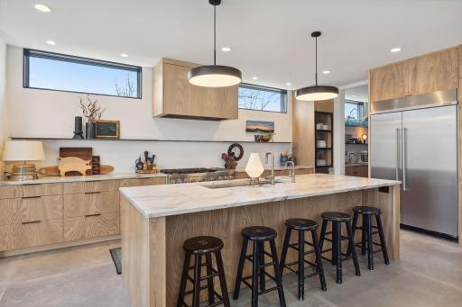 This sophisticated Kitchen features extensive custom cabinetry with soft-close doors and drawers and pull-out shelving.
