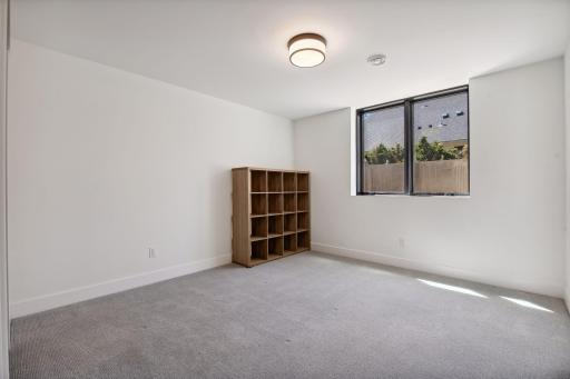 Two additional bedrooms are housed in the lower level. Each room offers a walk-in closet.