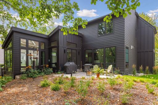 The backyard is an enchanting setting with professional landscaping by W Landscapes and impressive outdoor living spaces.