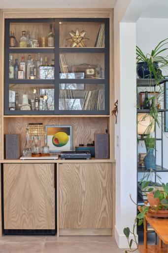 Situated next to the 48-inch refrigerator is a beautiful beverage bar that features a beverage refrigerator and custom glass-front cabinetry.