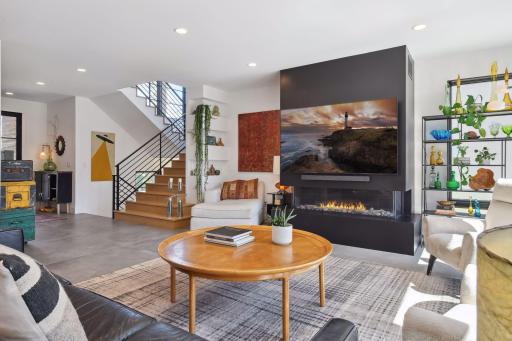 A linear, 3-sided fireplace is the focal point of the Family Room.
