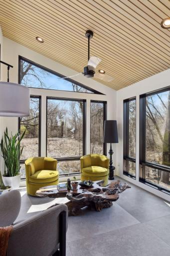 Nestled behind the Dining Room is the sun-drenched Four Season Porch that features a mono-pitch ceiling crafted with warm ash wood and heated floors.