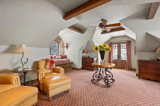 The upper level is the perfect space for guests, offering two built-in window beds and a three-quarter bathroom.