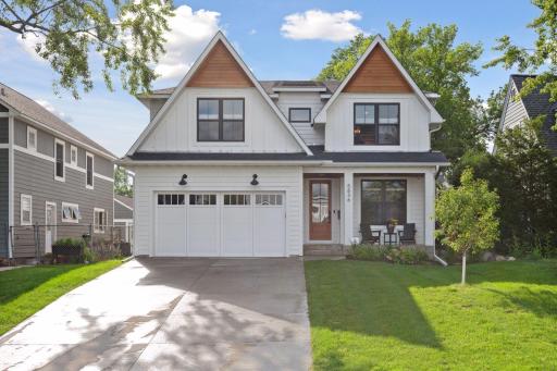 Proffessionally landscaped yeard with sprincle system, concrete dryway, and fenced backyard.