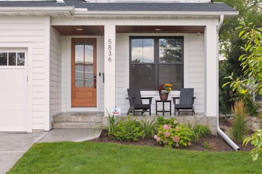 Welcoming front entry features stamped and stained front stoop.