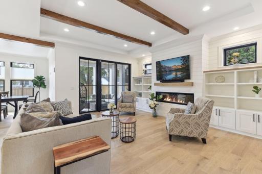 Living Room features white oak hardwood, vaulted ceiling with decorative beams.
