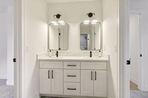 Jack and Jill bathroom with double vanities and heated tiled floors.