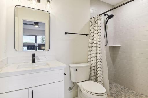 Junior suite bathroom features tiled walk-in shower and heated tiled floors.