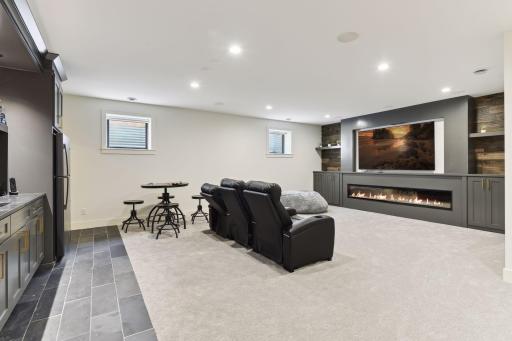 100" fireplace, wet bar, home theater with surround sound.