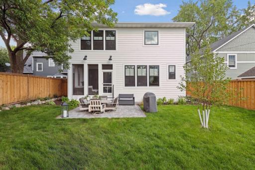 Landscaped backyard with sprinkler system & paver patio.