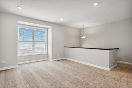 Open floorplan with a large family room and windows through-out. Photos are not of actual home. Actual home will be similar. Some colors and features may vary.