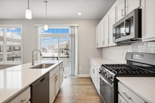 Kitchen opens to your own private deck. Great for summer grilling or enjoying your morning coffee. Photos are not of actual home. Actual home will be similar. Some colors and features may vary.