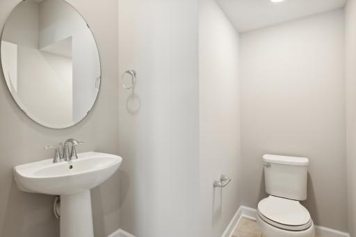 Convenient half bath on the main level which is great for guests. Photos are not of actual home. Actual home will be similar. Some colors and features may vary.