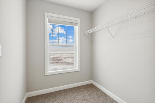 Large walk-in closet. Photos are not of actual home. Actual home will be similar. Some colors and features may vary.