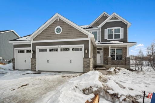Craftsman style architecture with a generous use of stone. Accents of port-hole window, shakes, shutters and columned front porch make up this beautiful exterior.
