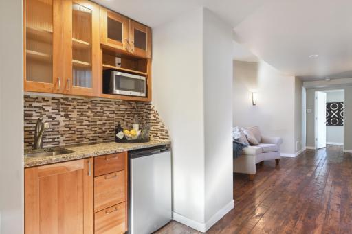 The lower level boasts a wet bar to entertain in style in your theatre space.