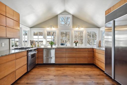Hand-scraped hickory floors and not just one kitchen sink window to enjoy the nature
