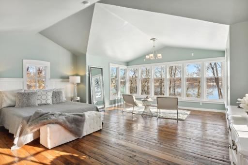 The primary bedroom, with peaked roof and wall of windows