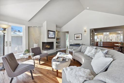 Home features artistic elements and custom finishes: hand-scraped hickory floors, bullnose corners, peaked roof, and amazing natural light filled rooms