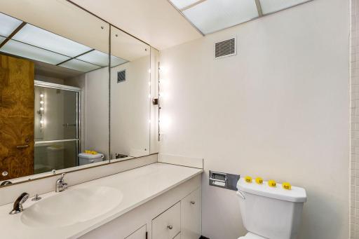 One of two lower level bedrooms with a private, full bathroom and private patio access.