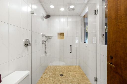 The primary bathroom features a spacious double vanity with built in storage, a separate soaking tub, a large walk-in shower and leads into the generous walk-in closet.