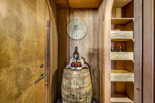 The generous wine cellar offers abundant space for wine and spirit collections.