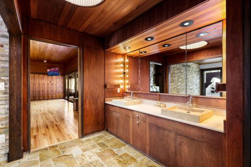 The primary bathroom features a spacious double vanity with built in storage, a separate soaking tub, a large walk-in shower and leads into the generous walk-in closet.