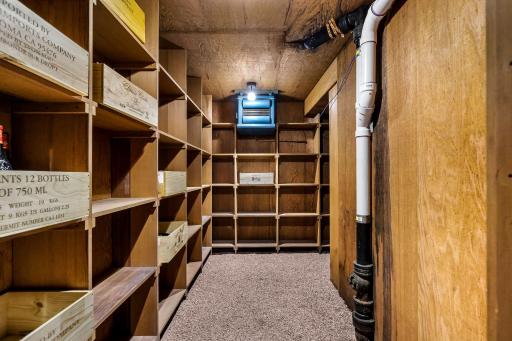 The generous wine cellar offers abundant space for wine and spirit collections.