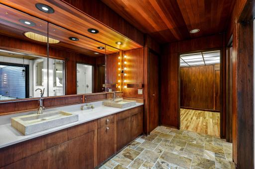 The primary bathroom features a spacious double vanity with built in storage, a separate soaking tub, a large walk-in shower and leads into the generous walk-in closet.