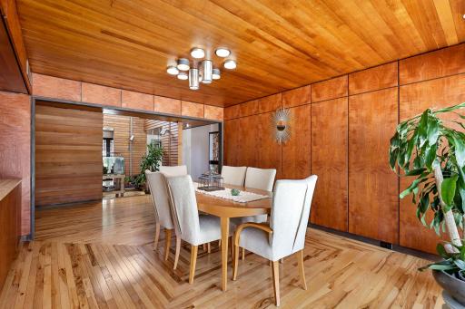 The bright and open formal dining space features a custom designed Hickory floor and a stunning bar/buffet for entertaining.