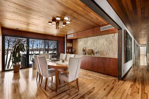 The bright and open formal dining space features a custom designed Hickory floor and a stunning bar/buffet for entertaining.