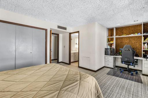 One of two lower level bedrooms with a private, full bathroom and private patio access.