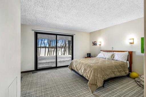 One of two lower level bedrooms with a private, full bathroom and private patio access.