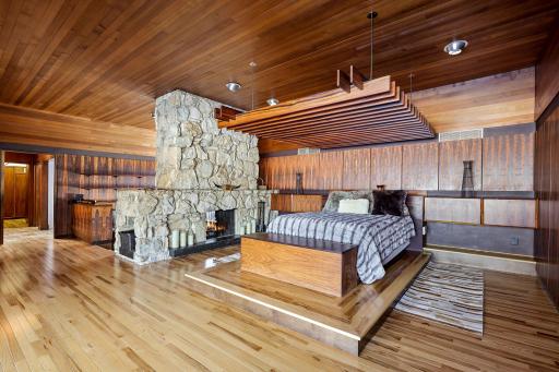 The primary suite features irreplaceable Brazilian Rosewood walls all cut from one tree, a built-in platform bed (adjustable to king or queen) with teak pergola, expansive views, and a sunk in sitting den with double-sided, see-through fireplace.
