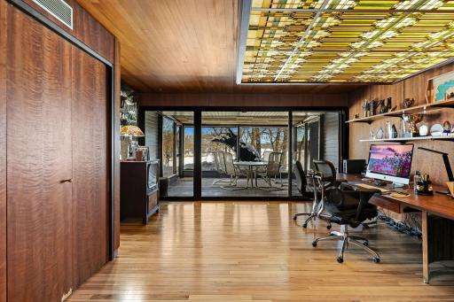 The office, nursery or extra bedroom off the primary has custom one of a kind-stained glass lighting and walks out to a screened in porch offering stunning views.