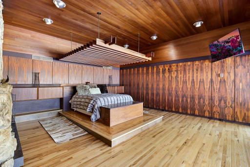 The primary suite features irreplaceable Brazilian Rosewood walls all cut from one tree, a built-in platform bed (adjustable to king or queen) with teak pergola, expansive views, and a sunk in sitting den with double-sided, see-through fireplace.