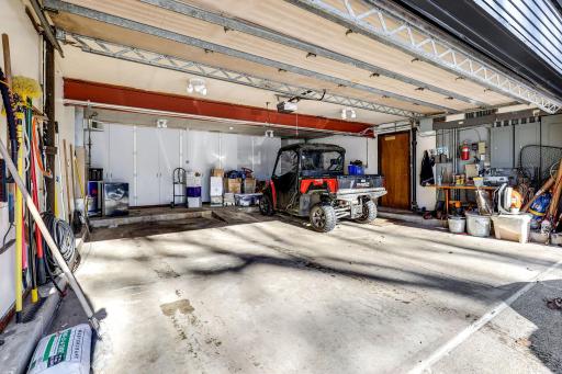 The 4-car, insulated, heated and cooled garage offers an entire back wall of storage cabinets.
