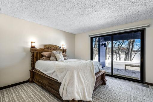 The second of two lower level bedrooms with a private, full bathroom and private patio access.