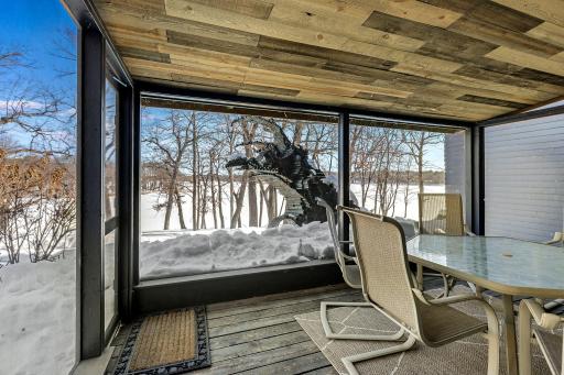 The office, nursery or extra bedroom off the primary has custom one of a kind-stained glass lighting and walks out to a screened in porch offering stunning views.
