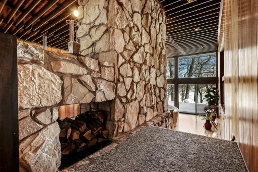 One of 4 stunning stone fireplaces throughout the home.