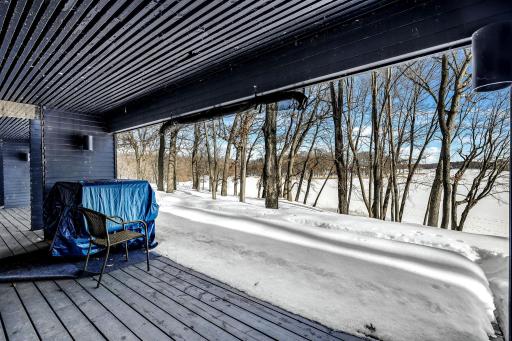 The lower level walks out to covered patio spaces with stunning lake views.
