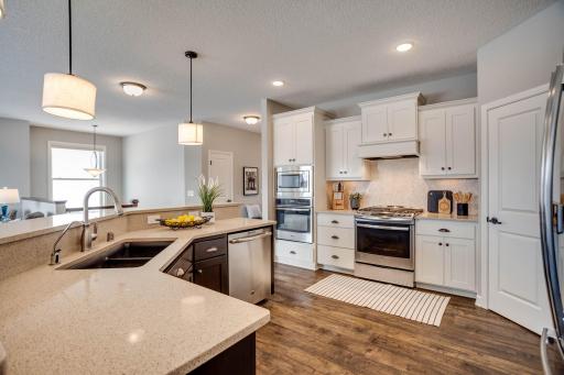 Incredible amenities: upgraded quartz countertops in the island & perimeter, stainless appliances, walk-in pantry, and custom cabinets.