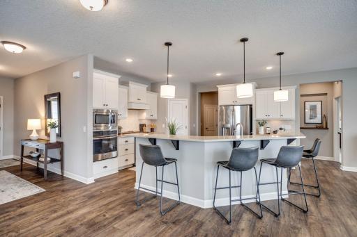 The centrally located, gourmet kitchen is loaded with bells & whistles! Beautiful and durable, this gorgeous hard flooring flows throughout the entry, kitchen and dining room.