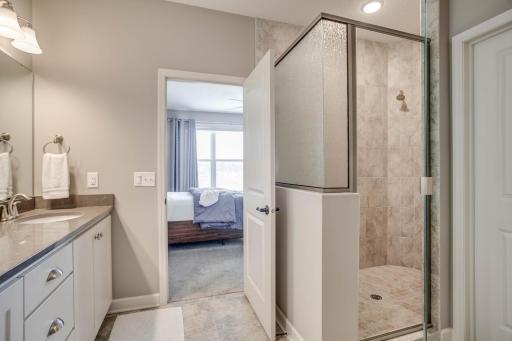 The walk-in shower was beautifully upgraded with tile flooring and surround + the large, walk-in closet is also tucked away within the bathroom area.
