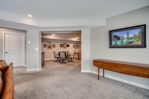 Open flow between the family room, walk-out entry, and the adjoining game room.