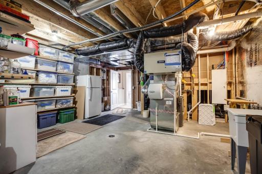 A huge bonus, the home boasts an incredible amount of storage space.....home to the mechanicals (dual zone HVAC), workbench, utility sink & an abundance of storage.