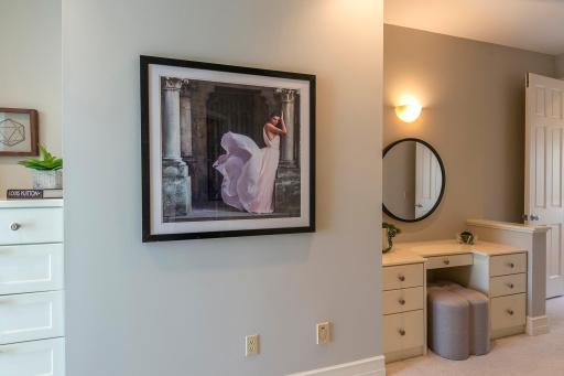 Enjoy getting ready at your own vanity in the primary bedroom.