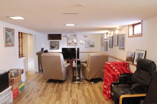 Current photo of basement shows new flooring and walls