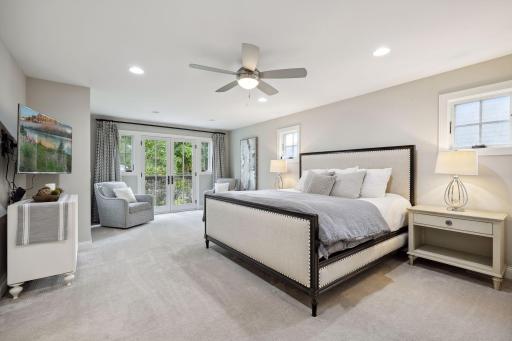 The primary bedroom features a Juliet balcony and spa-like bath with a separate walk-in shower, soaker tub, and walk-in closet.